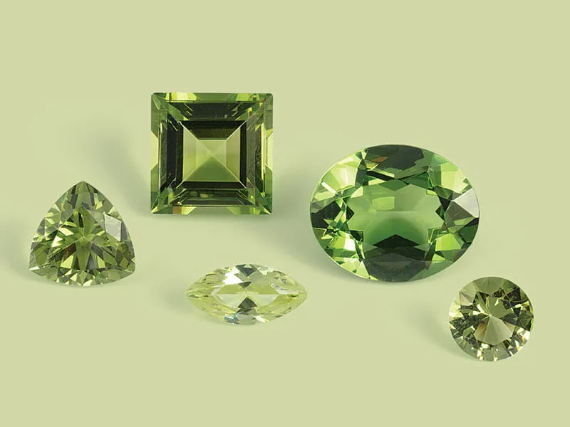 A group of green gemstones on a green background.