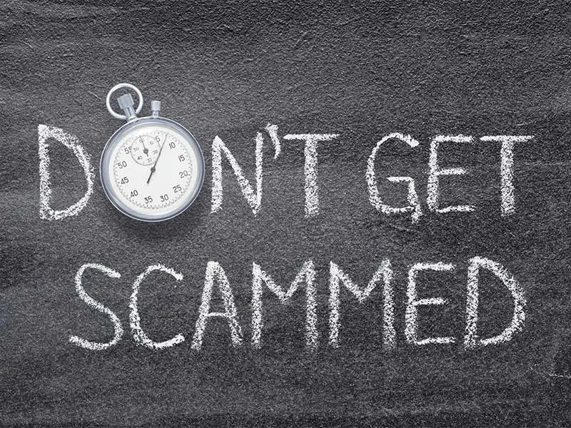 Don't get scammed written in chalk on a blackboard.