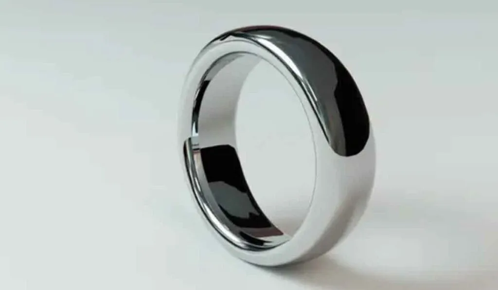 A shiny silver ring with a smooth surface, standing upright on a neutral background.